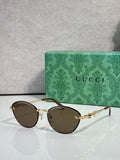 Gold metal sunglasses with dark brown lenses and chain-link temple details