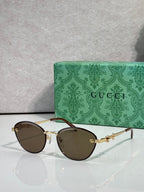 Gold metal sunglasses with dark brown lenses and chain-link temple details