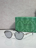 Silver metal sunglasses with dark lenses and chain-link temple details