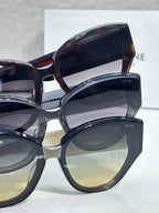 Celine sunglasses with mixed dark frames and tinted lenses, layered close-up view.