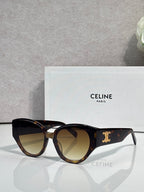 Celine sunglasses with black tortoiseshell frames, gold logo detail, tinted lenses.