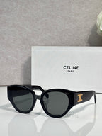 Celine sunglasses with glossy black frames and dark smoke lenses, gold logo on temple.