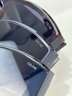 Celine sunglasses temple close-up with engraved brand text on dark tortoiseshell.