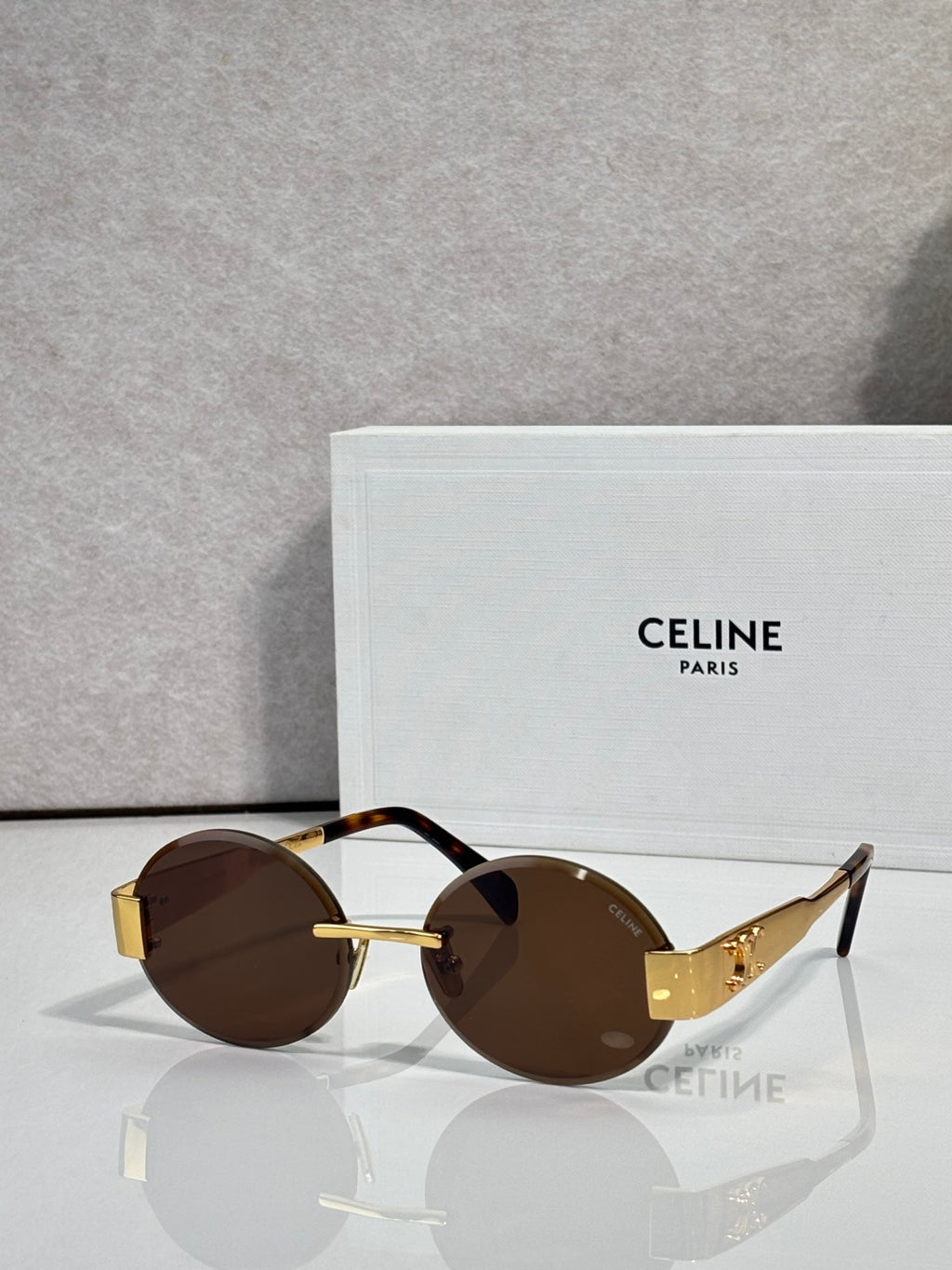 Celine sunglasses with round brown lenses and tortoise-pattern frame with gold-tone details