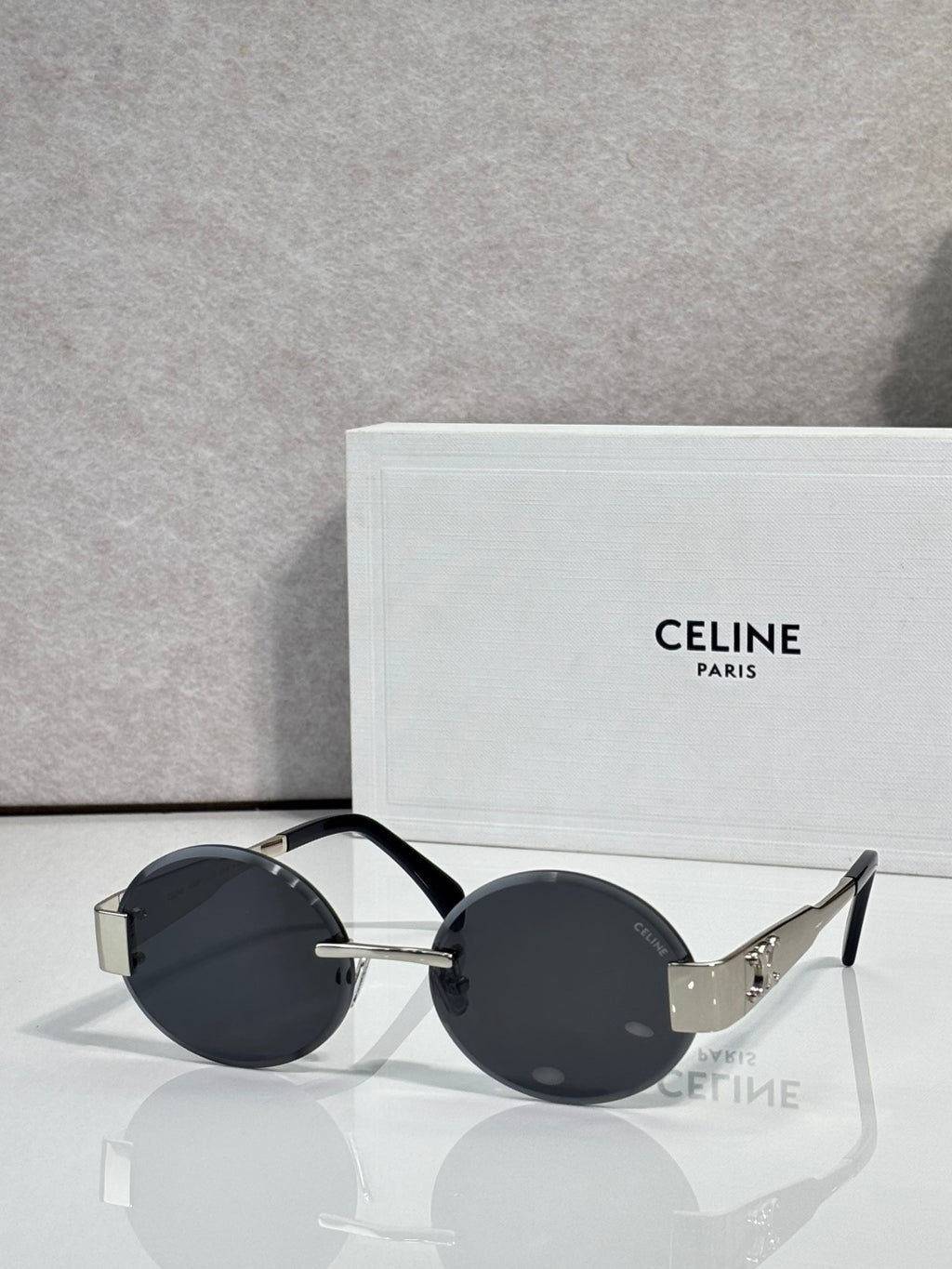 Celine sunglasses with round dark lenses and black frame, gold-tone temple tips