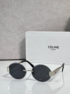 Celine sunglasses with round dark lenses and black frame, gold-tone temple tips