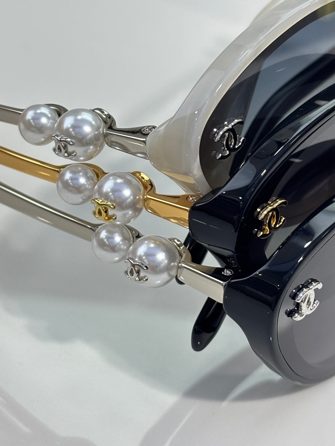 Chanel sunglasses close-up: pearl beads and gold/silver temple hardware