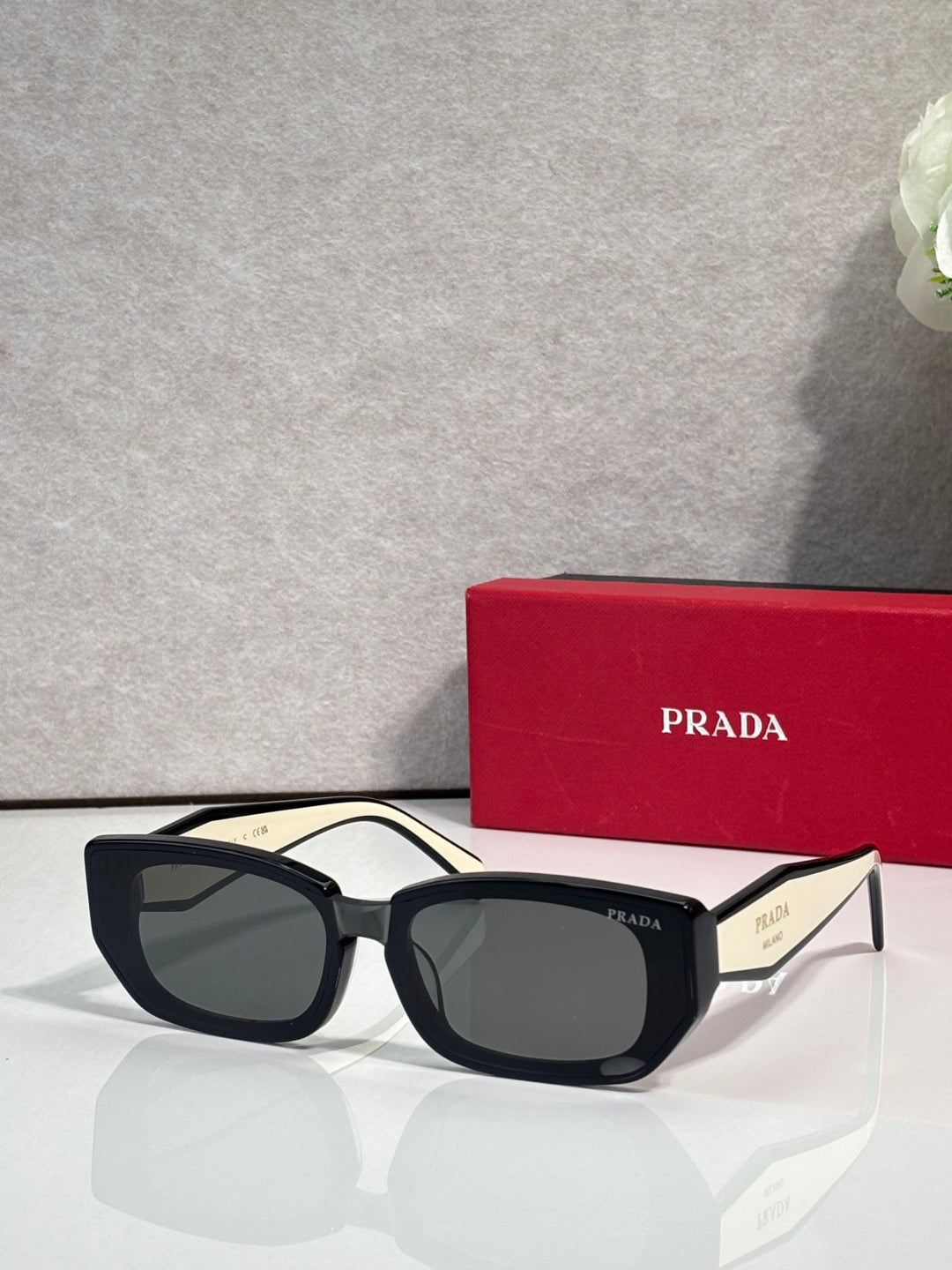 Prada sunglasses with black frame and dark tinted lenses, cat-eye style