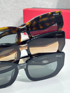 Prada sunglasses close-up with tortoise acetate frame and dark tinted lenses