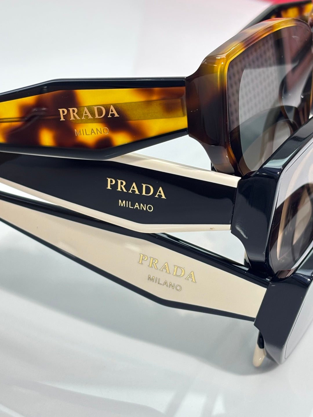 Prada sunglasses close-up with tortoise frame and printed temple branding