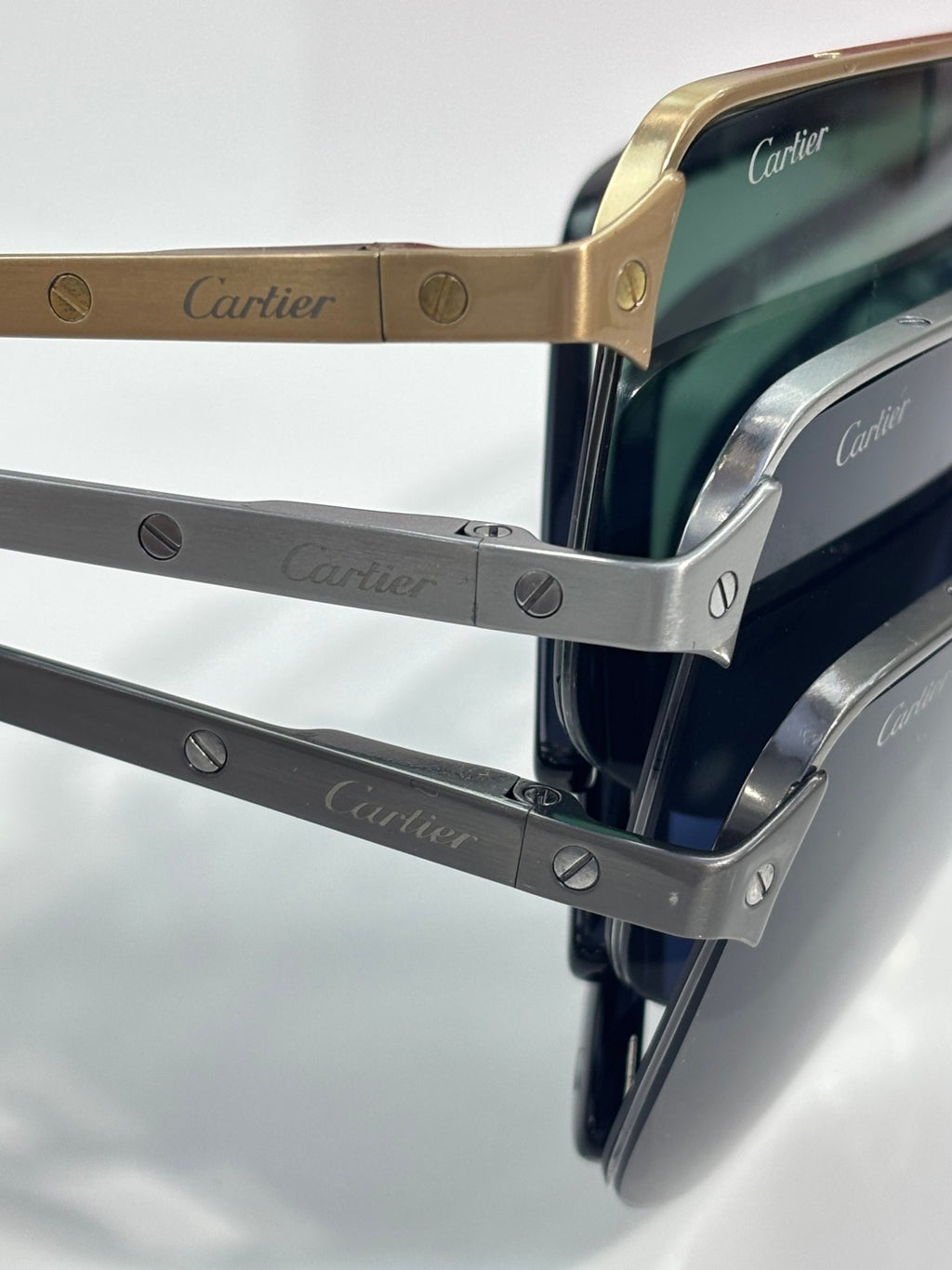 Cartier eyeglass temples close-up with engraved logos on metal arms