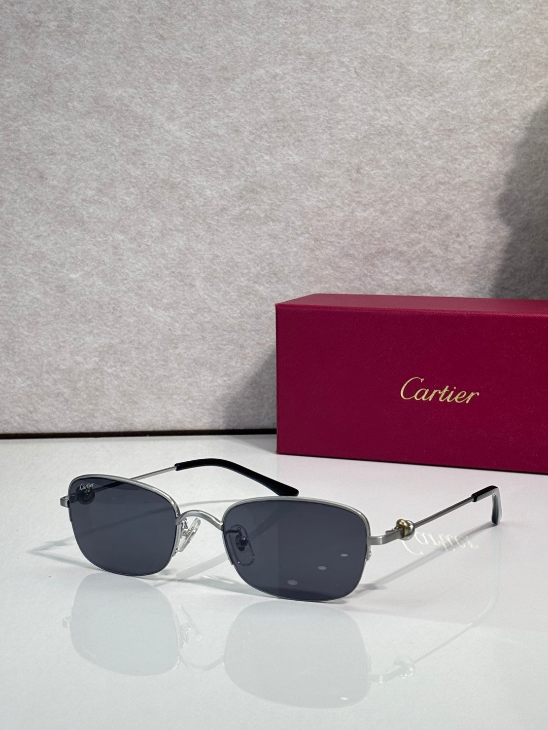 Cartier sunglasses with dark blue lenses and two-tone metal temples