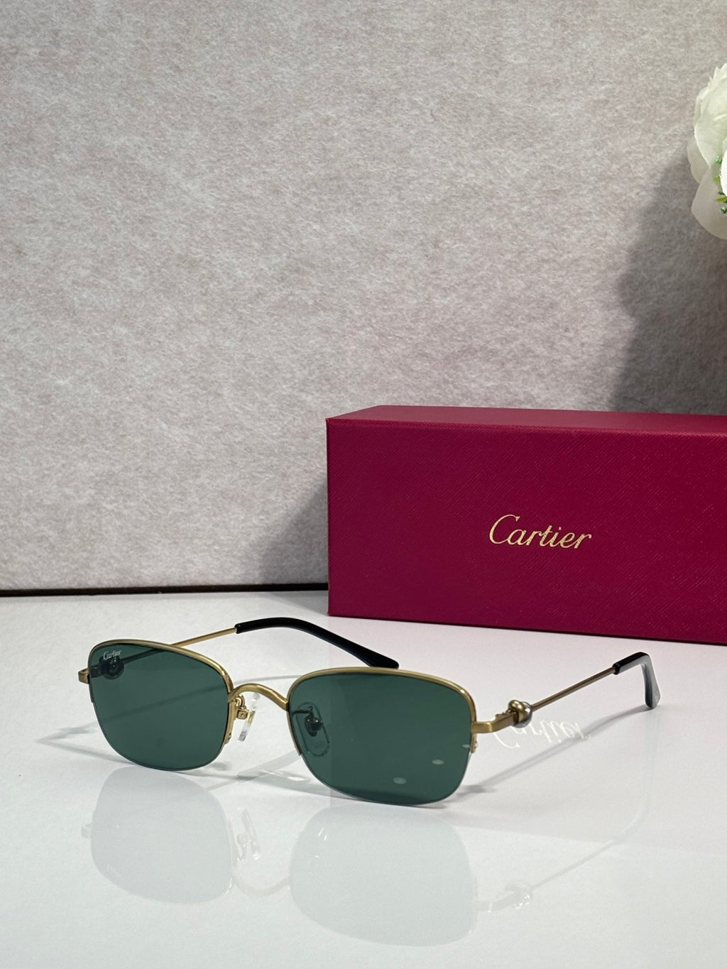 Cartier sunglasses with dark green lenses and gold-and-black metal frames