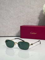 Cartier sunglasses with dark green lenses and gold-and-black metal frames