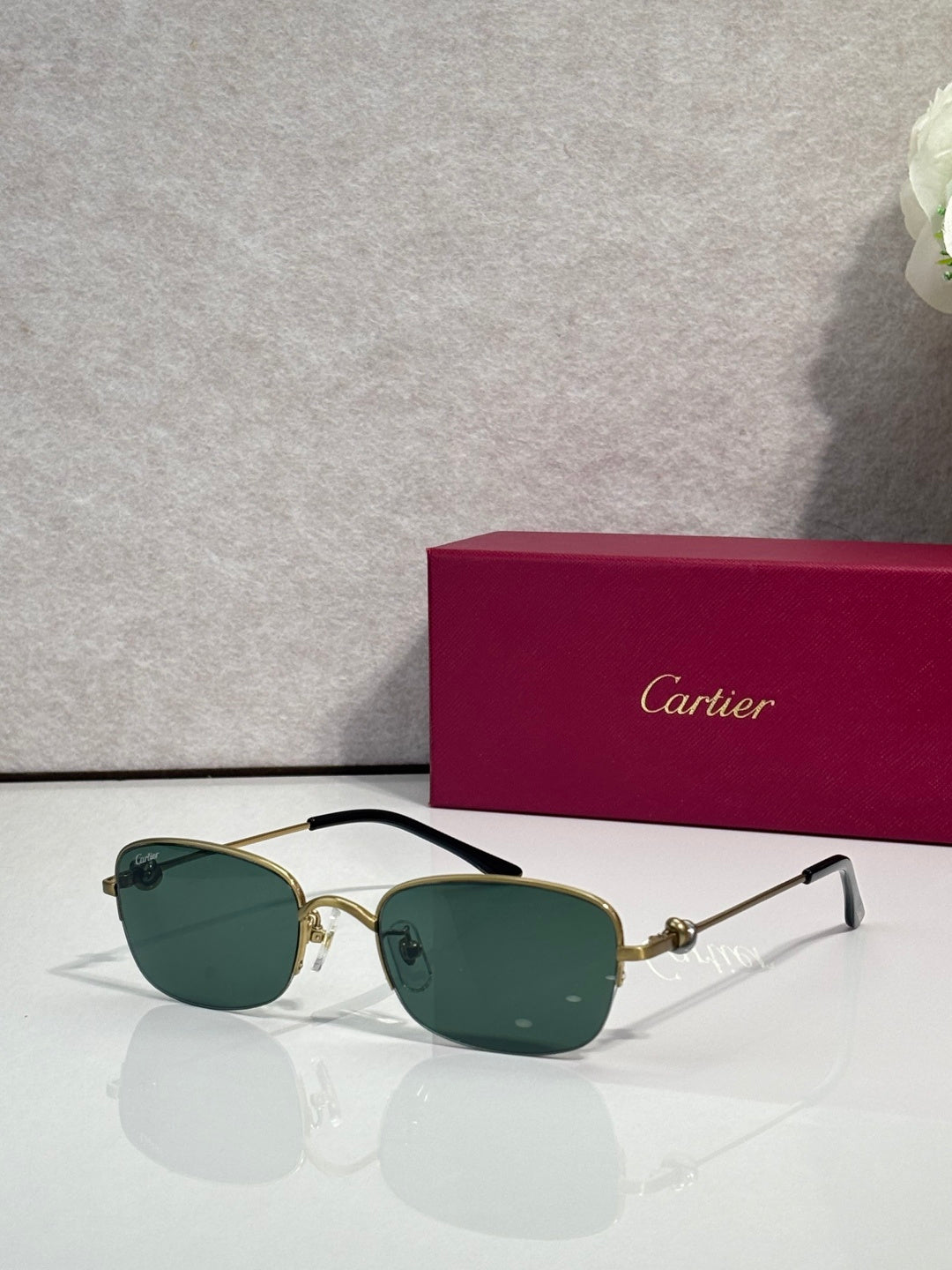Cartier sunglasses with dark green lenses and gold-and-black metal frames