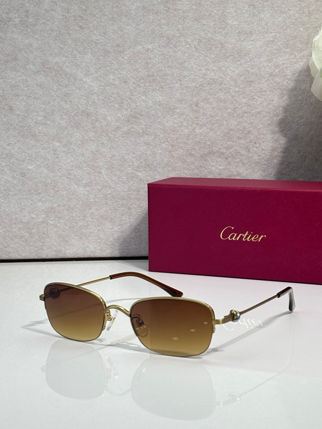 Cartier sunglasses with amber-tinted lenses and gold-tone metal frames