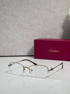 Cartier glasses with clear lenses, gold metal frame and dark temples