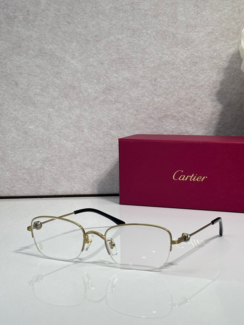 Cartier glasses with clear lenses, gold metal frame and dark arms