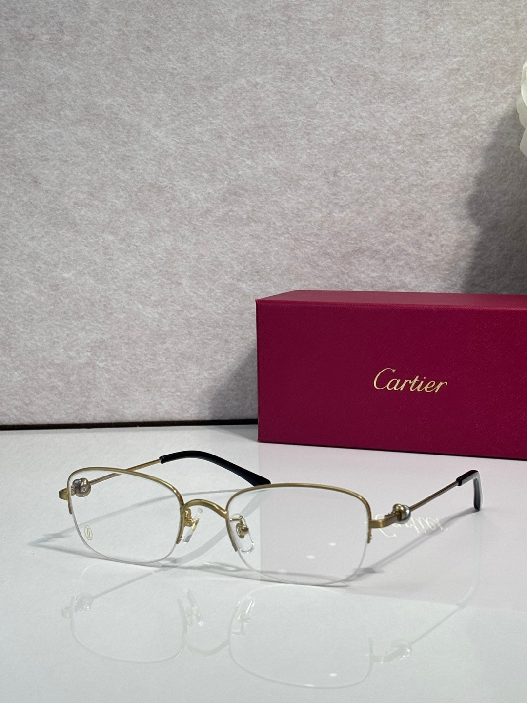 Cartier glasses with clear lenses, gold metal frame and dark arms