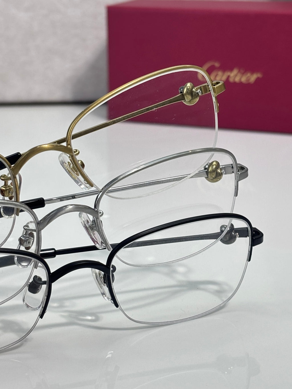 Cartier glasses with clear lenses, gold and silver frames with dark accents