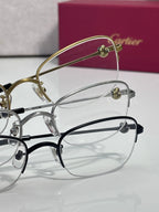 Cartier glasses with clear lenses, gold and silver frames with dark accents