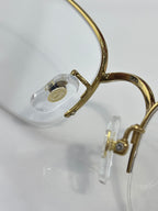 Cartier glasses close-up: gold frame ring and clear lens insert