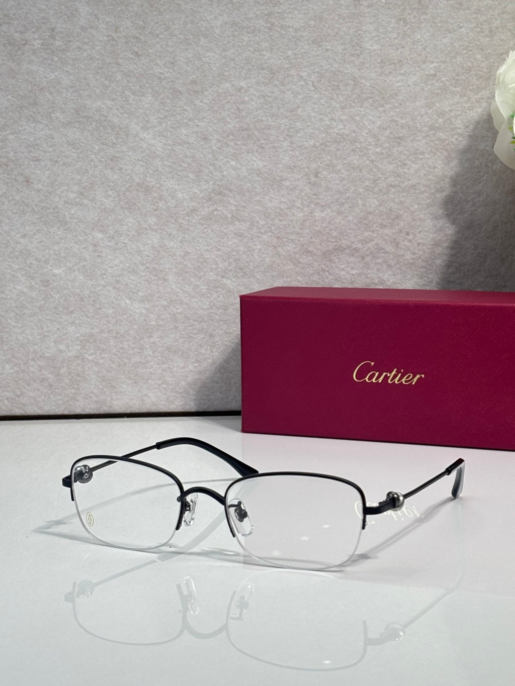 Cartier glasses with clear lenses, black metal frame and dark temples