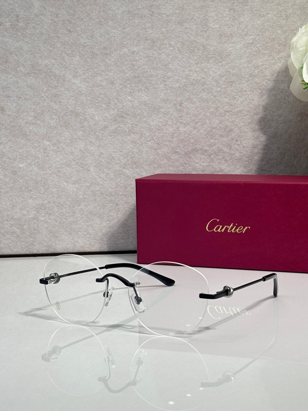 Black eyeglasses with clear lenses and metal details, thin frame with round shape
