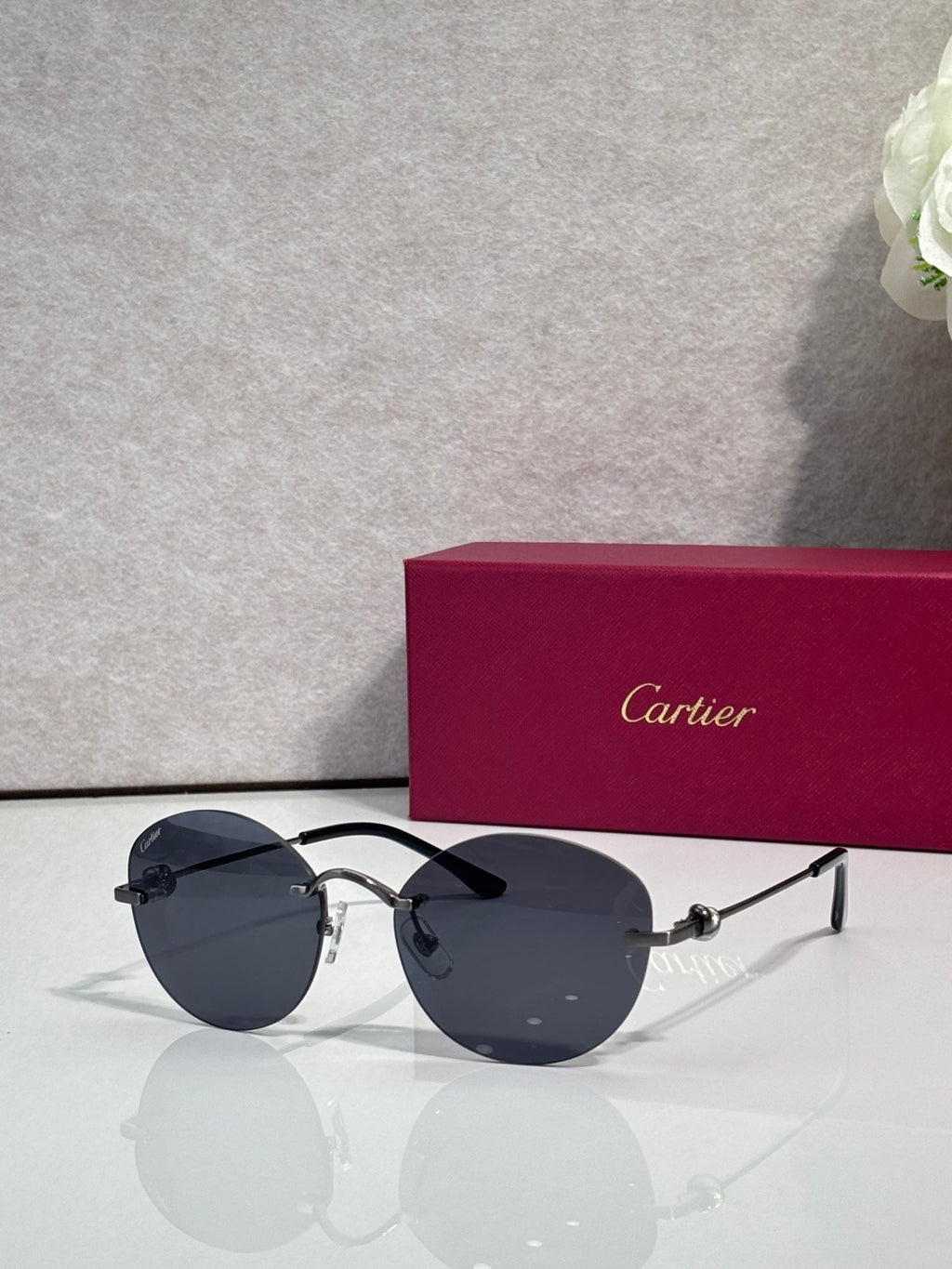 Cartier round sunglasses with dark lenses and silver-tone metal frame with gold details