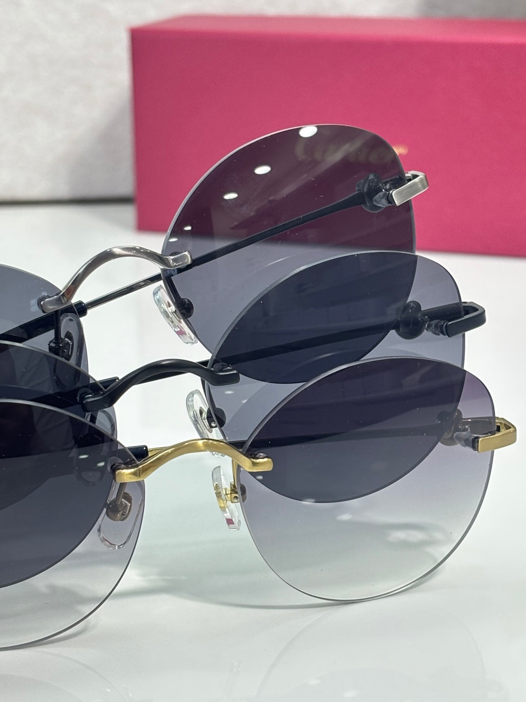 Cartier round sunglasses closeup with stacked frames, dark lenses, and metal temples