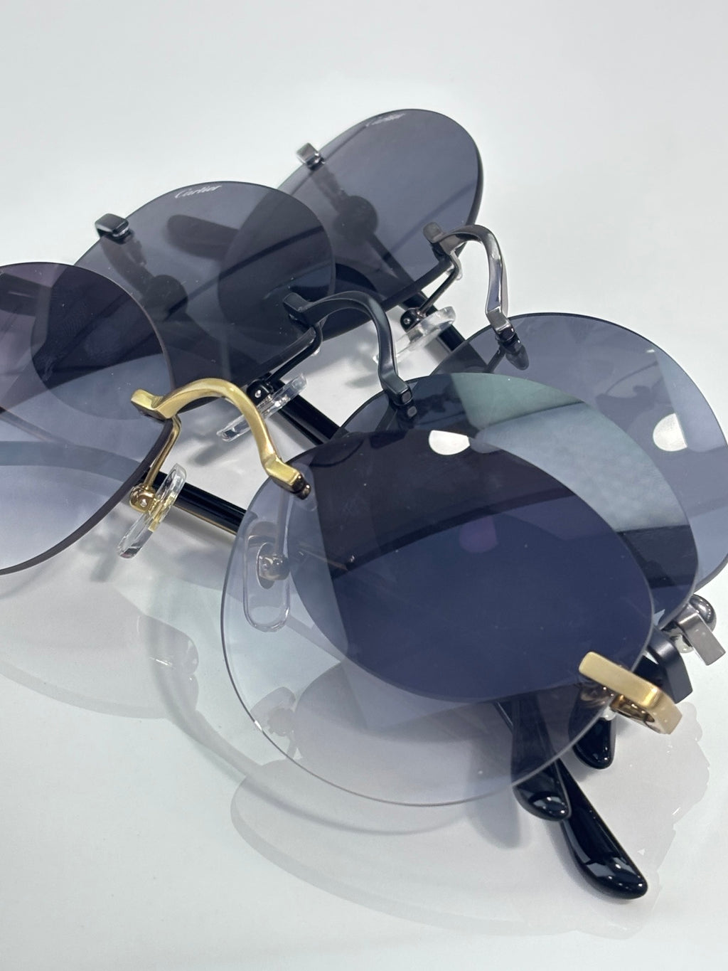 Cartier round sunglasses with dark lenses and gold accents on the bridge and temples