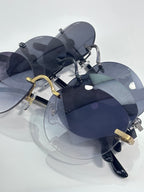 Cartier round sunglasses with dark lenses and gold accents on the bridge and temples