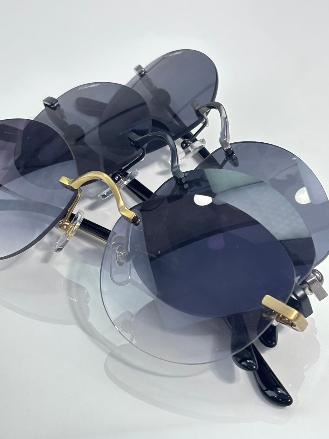 Cartier round sunglasses with dark lenses and gold accents on the bridge and temples