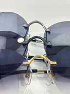 Cartier round sunglasses closeup with stacked lenses and metal nose pads