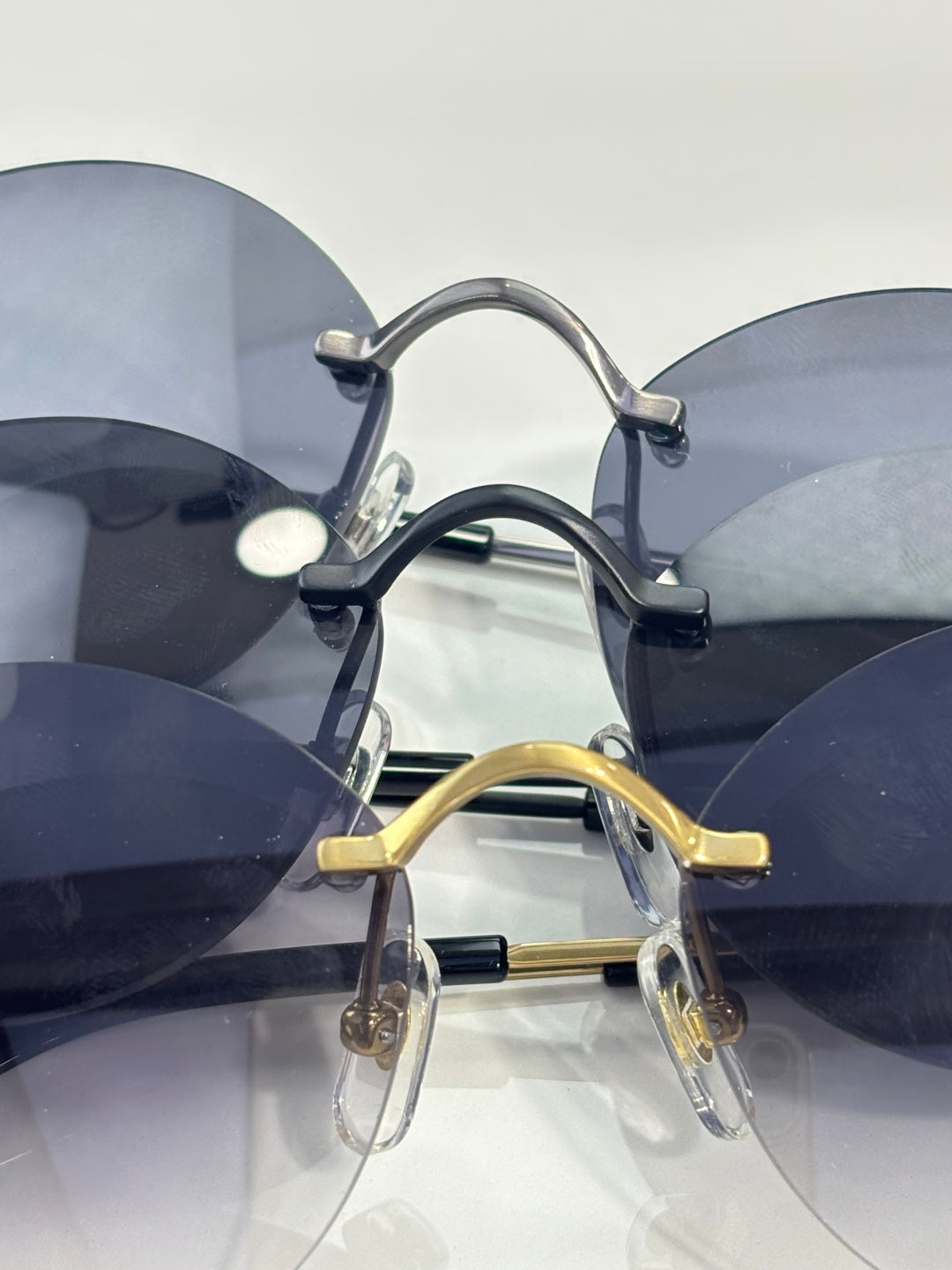 Cartier round sunglasses closeup with stacked lenses and metal nose pads