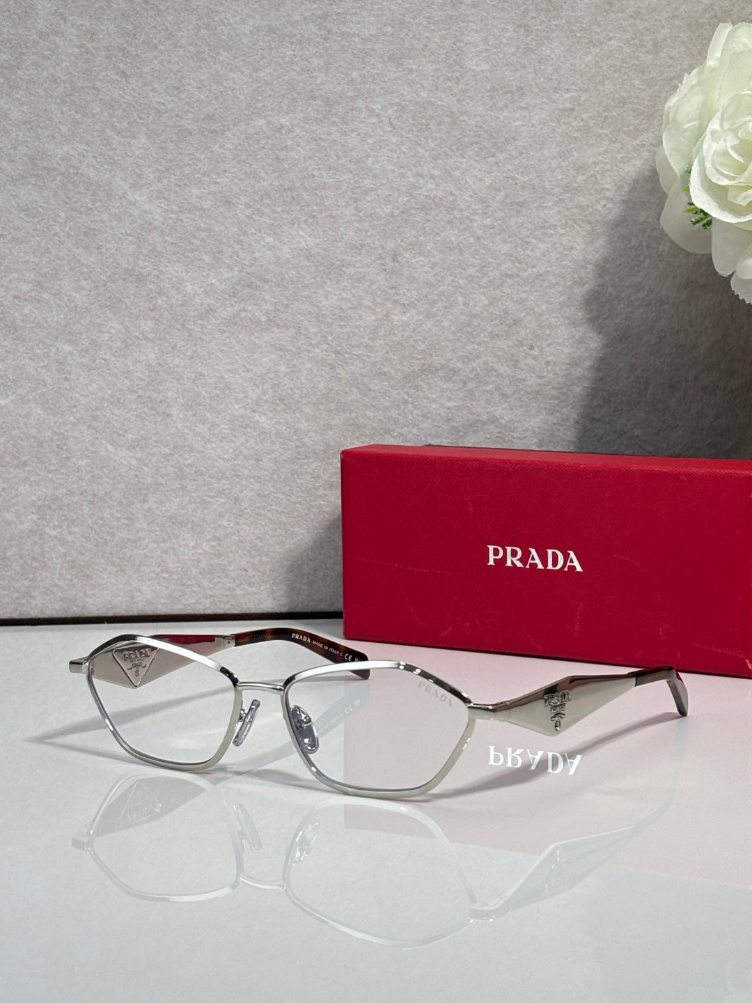 Prada optical glasses, silver metal frame, clear lenses, front view