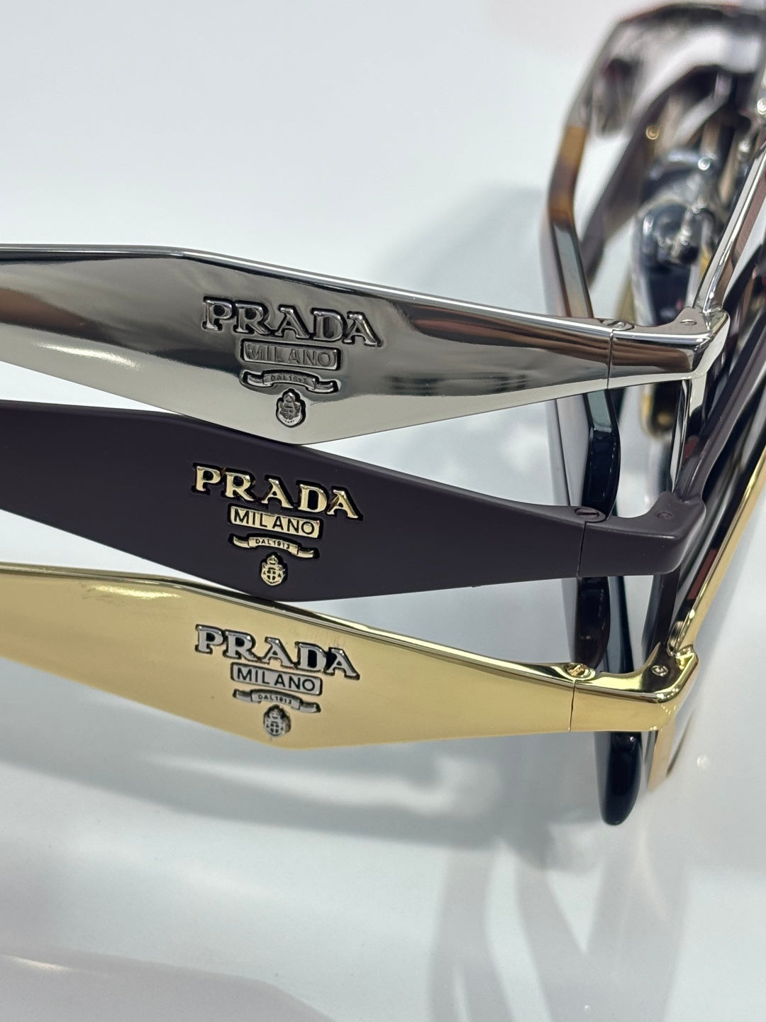 Prada sunglasses arms close-up with engraved PRADA MILANO and gold accents