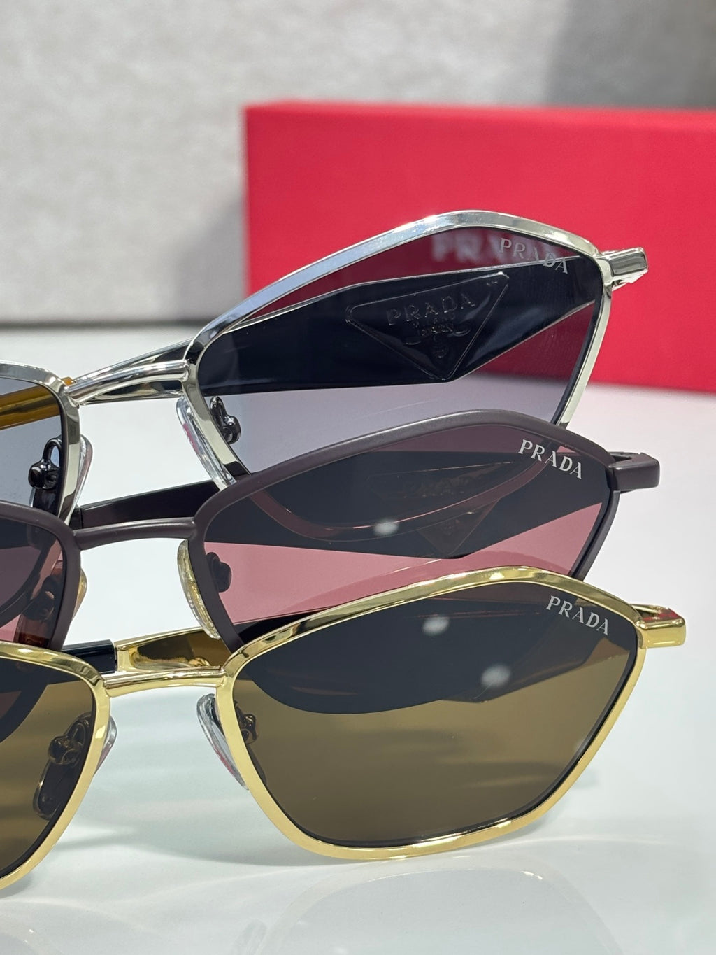 Prada sunglasses with mixed frames and dark lenses, PRADA logos on temples