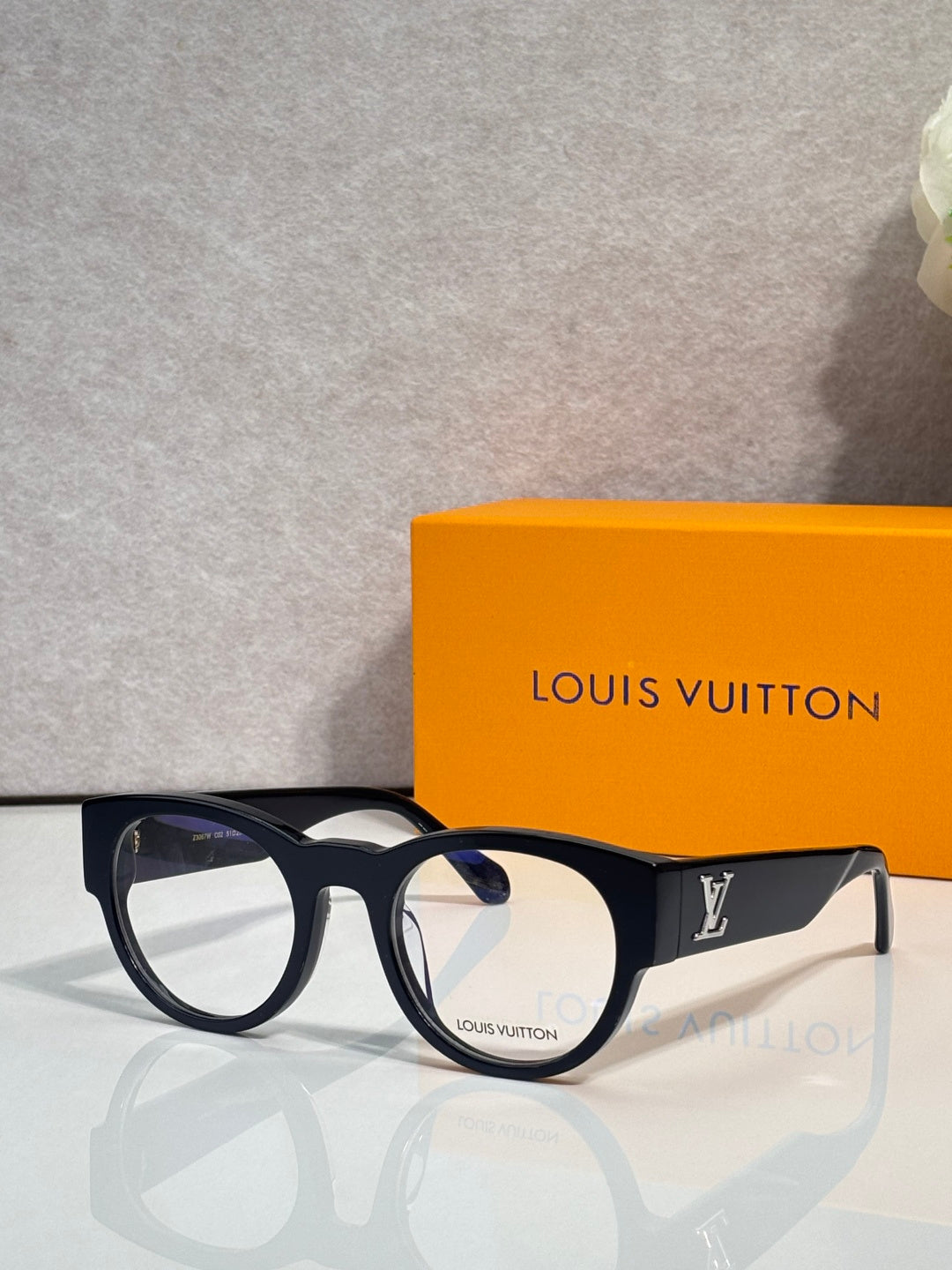 Eyeglasses with dark blue-black frame and clear lenses, Louis Vuitton logo temple