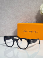 Eyeglasses with dark blue-black frames and white-toned arms