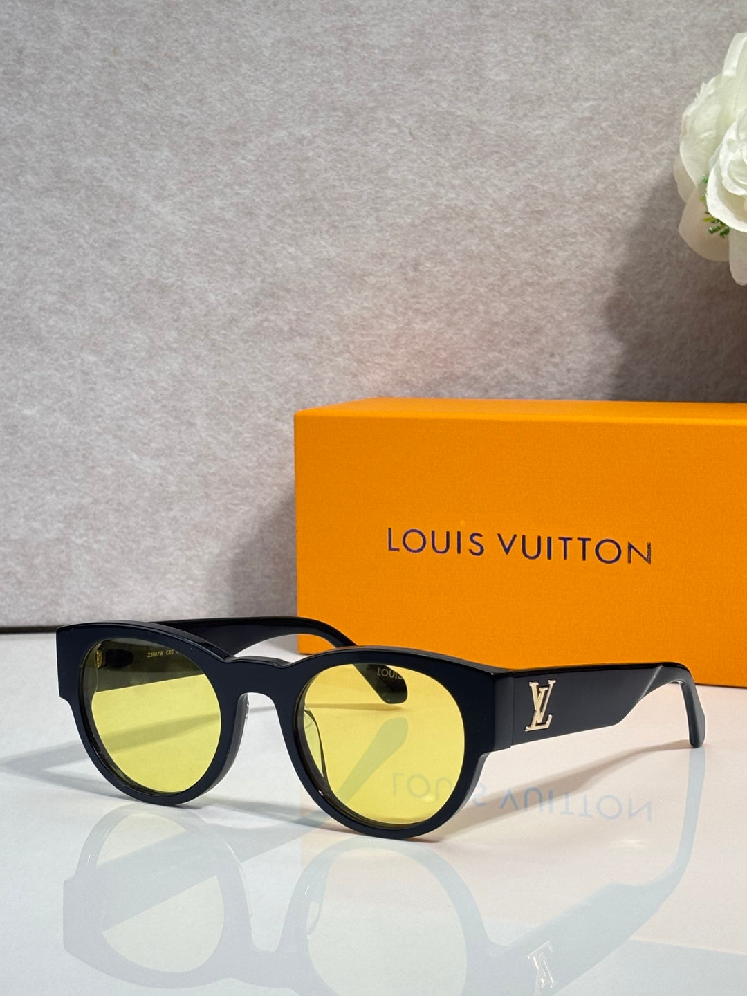 Louis Vuitton sunglasses with dark lenses and black rounded frames