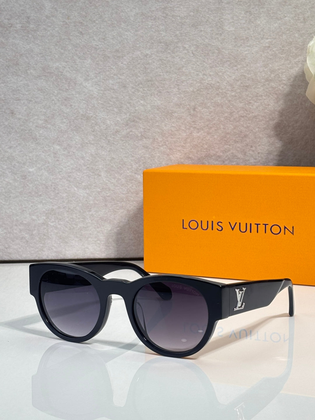 Sunglasses with black frames and dark purple-tinted lenses