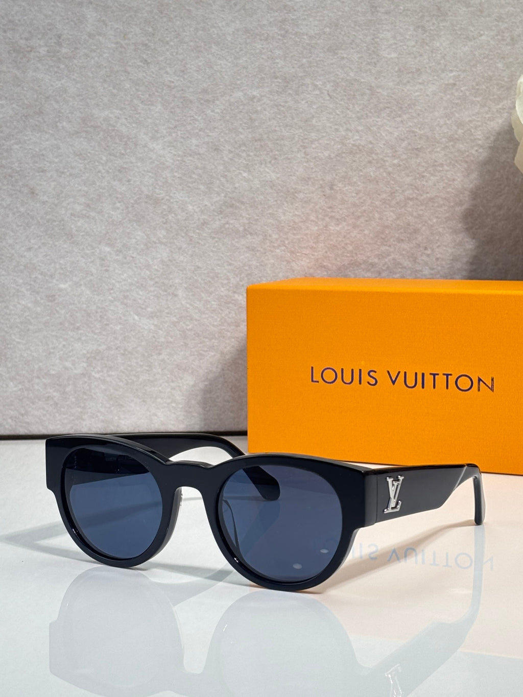Sunglasses with dark lenses and black frames, blue tint