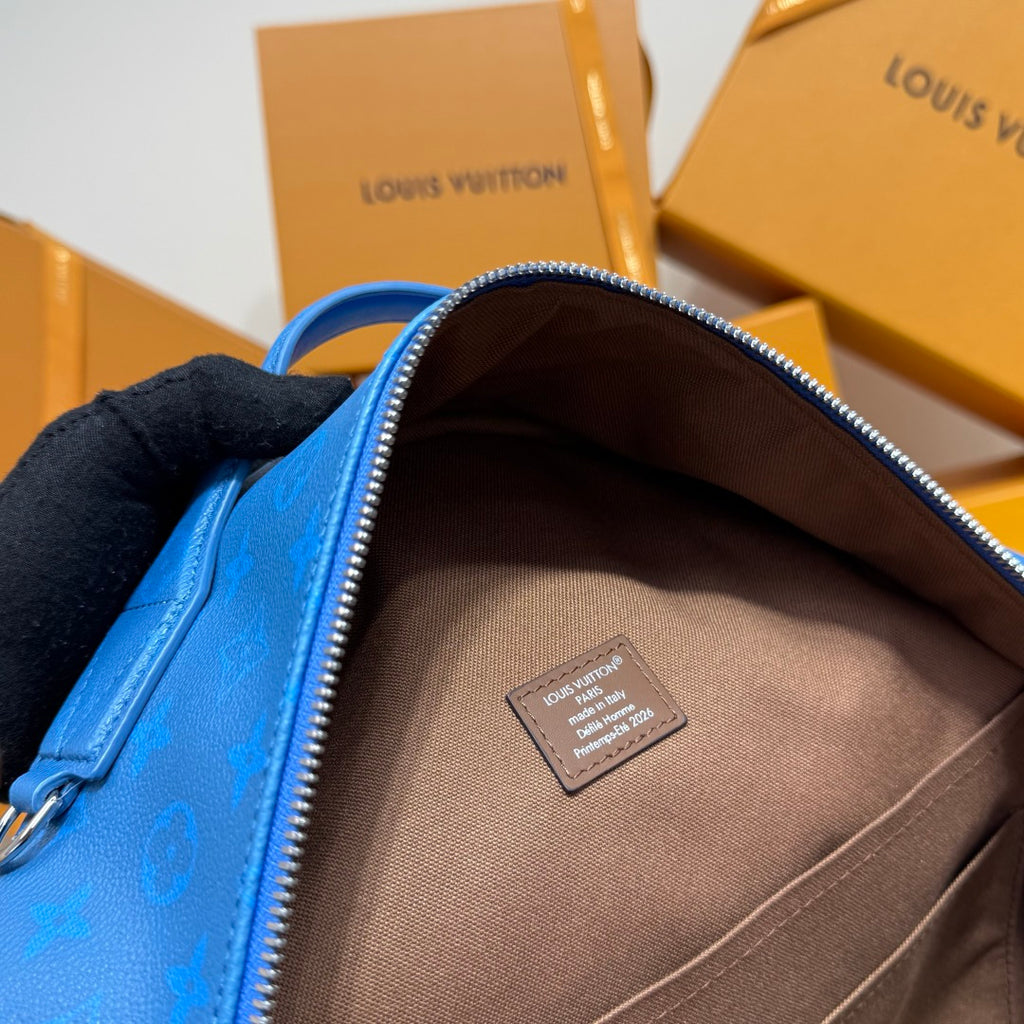 Blue monogram backpack interior with beige lining and rectangular brand patch