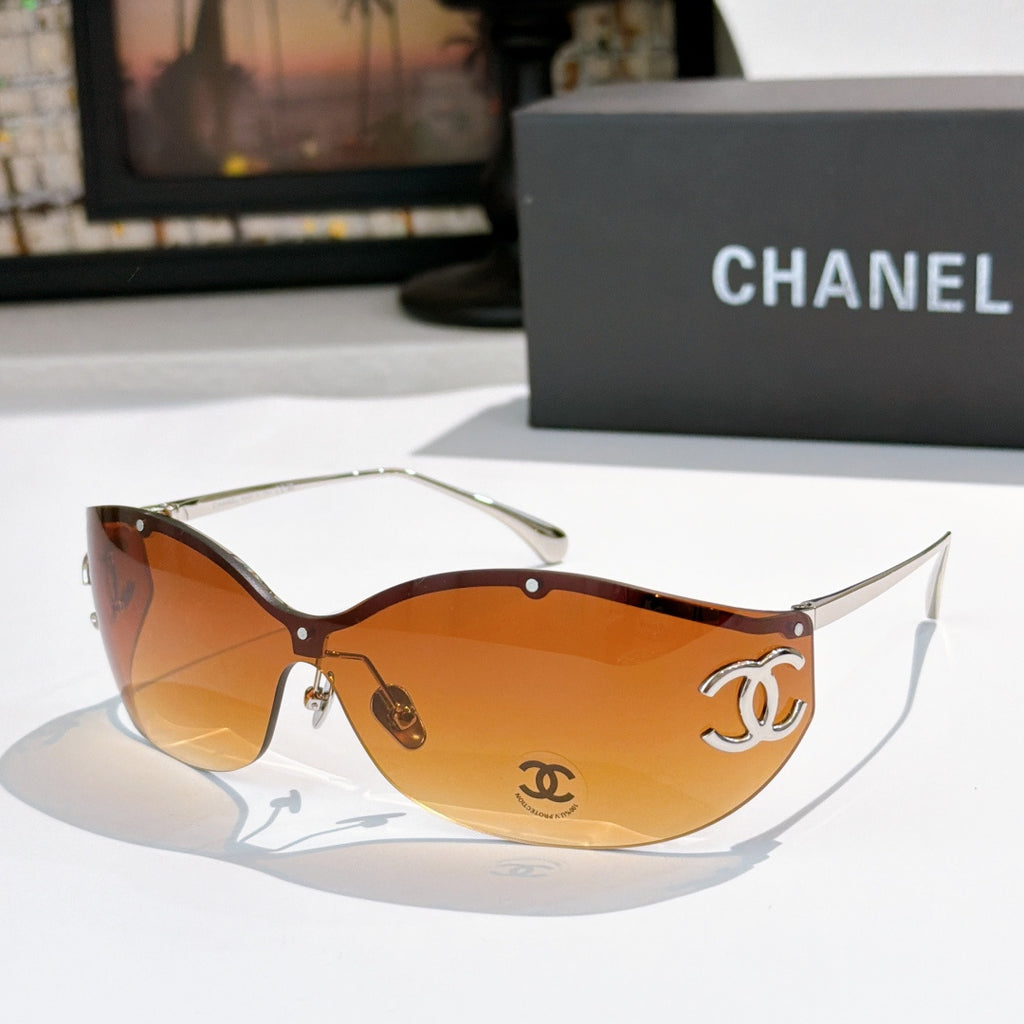 Brown cat-eye sunglasses with orange-tinted lenses and gold-tone logo hardware
