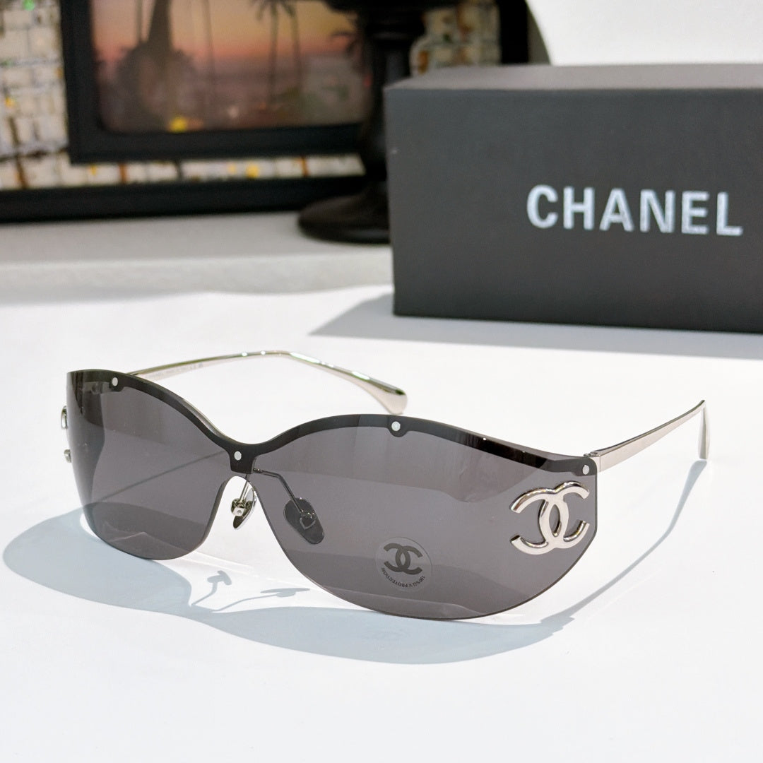 Black cat-eye sunglasses with dark gray lenses and gold-tone logo hardware
