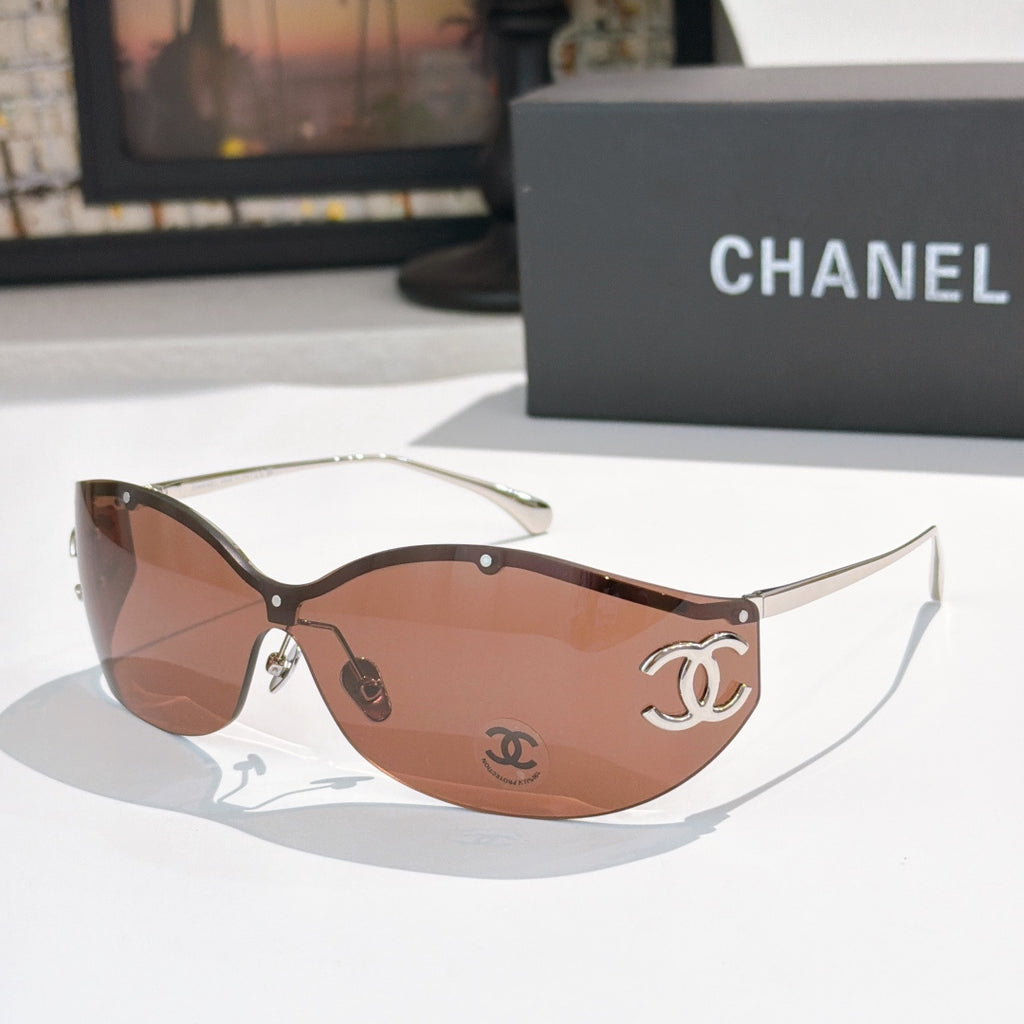Brown cat-eye sunglasses with tinted lenses and gold-tone logo hardware