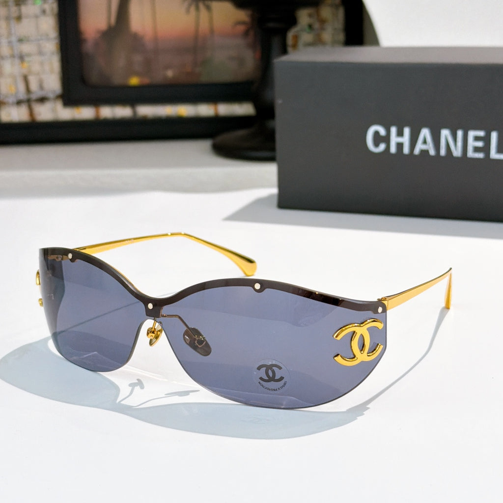 Dark brown cat-eye sunglasses with amber-tinted lenses and gold-tone logo hardware