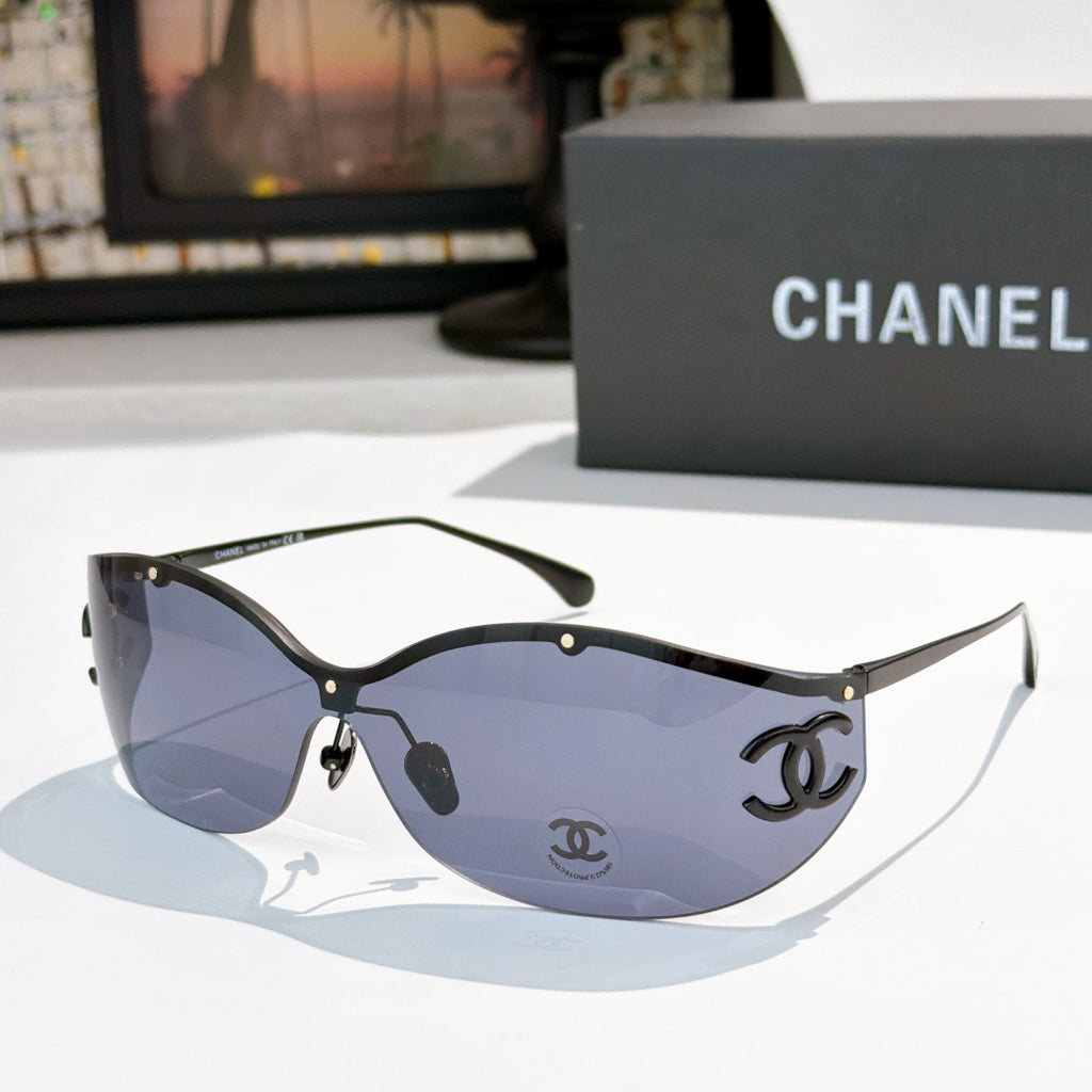 Black cat-eye sunglasses with blue-tinted lenses and gold-tone logo hardware