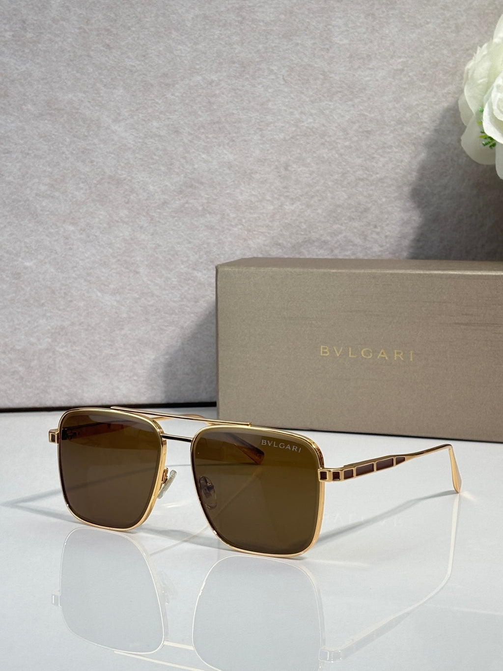 Bvlgari sunglasses with brown tinted lenses and gold-tone square frames